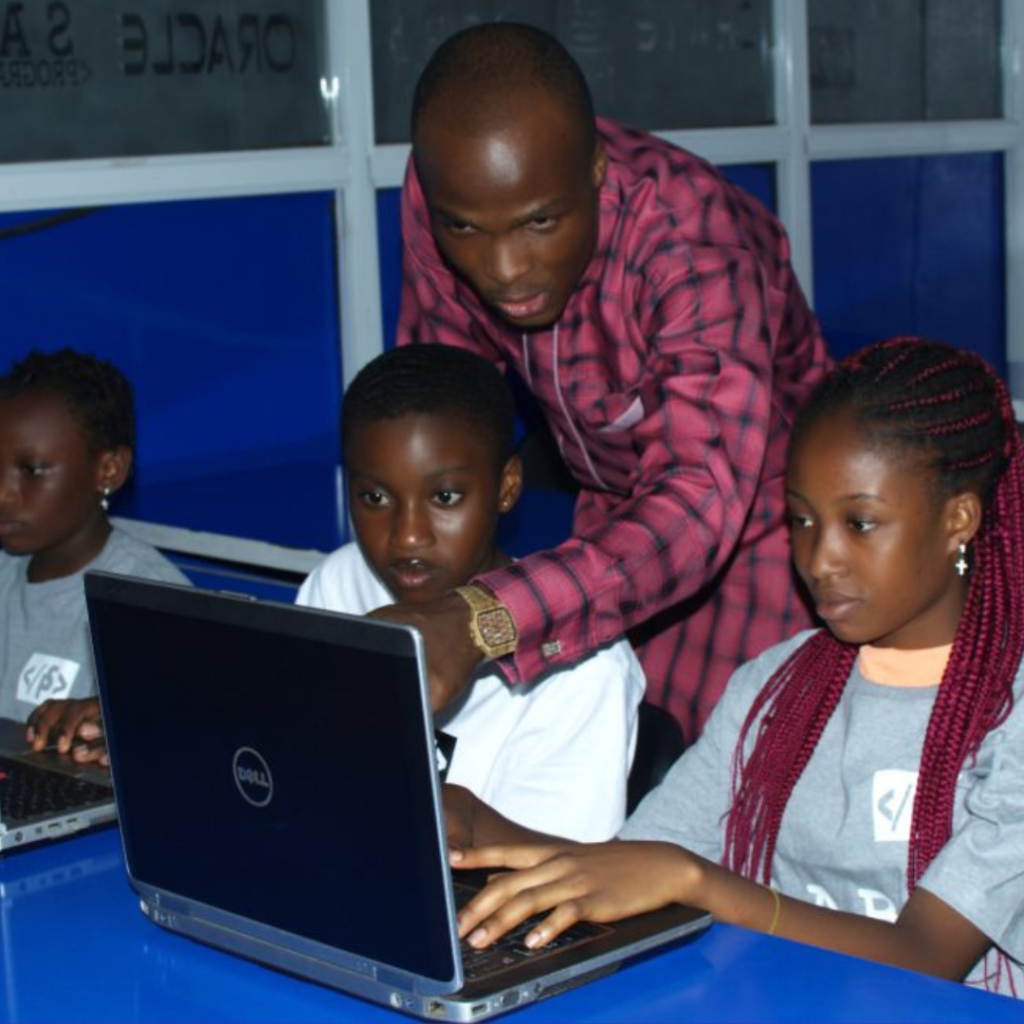 Teachers participating in an online training session with laptops.