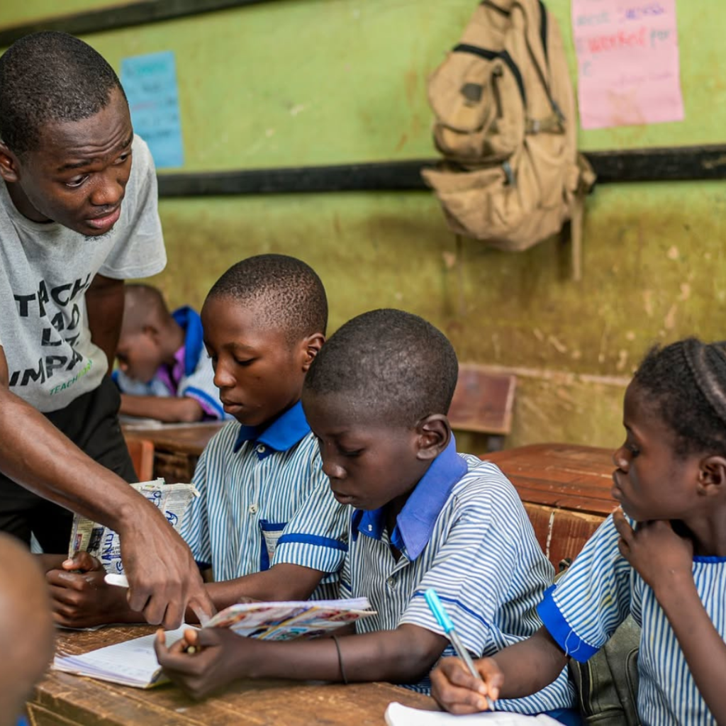 A teacher demonstrating an educational app to Nigerian students.