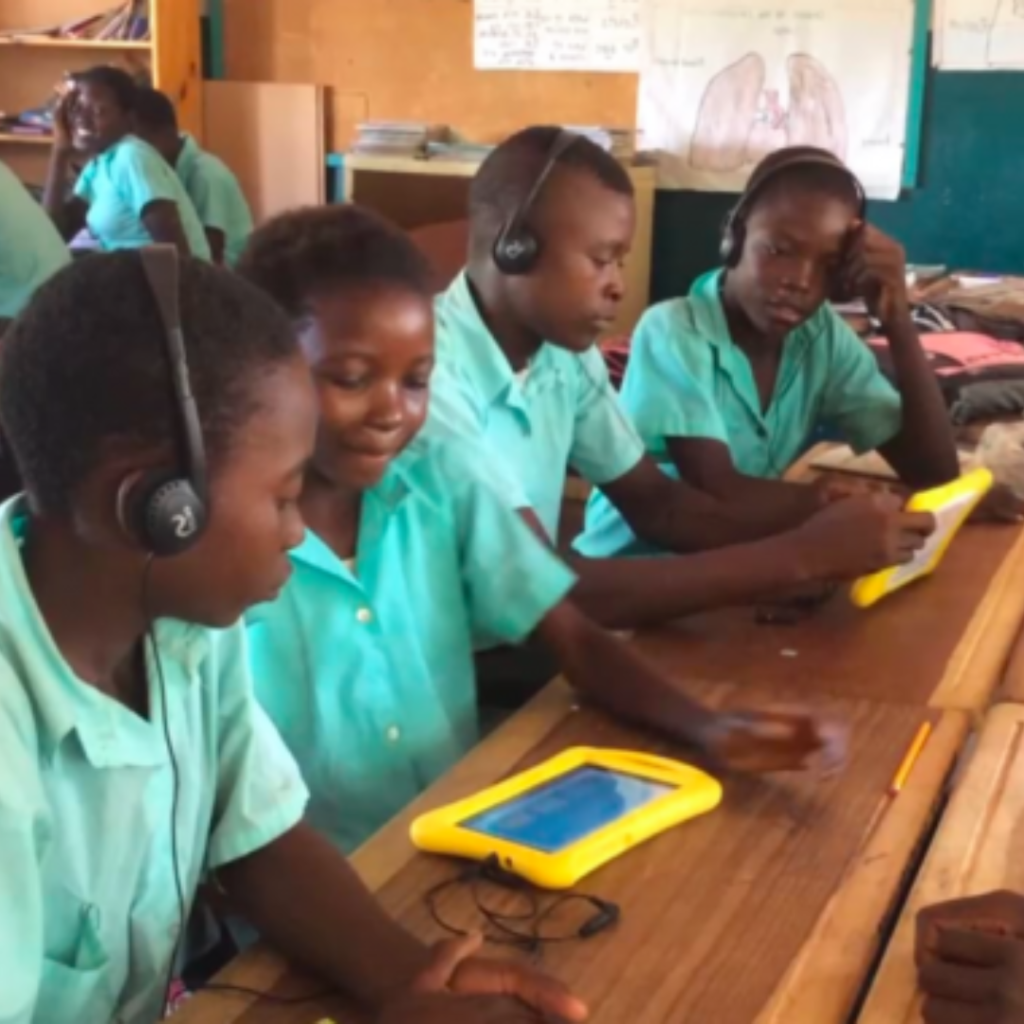 A group of students in a rural Nigerian community using tablets