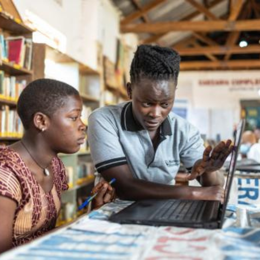 A rural library with students learning from digital devices.