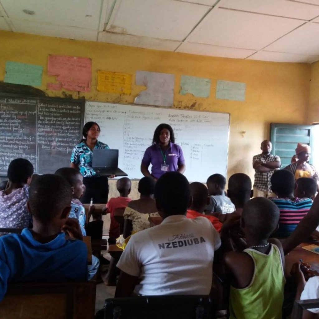 A group of young Nigerians participating in a digital skills training session at a library.